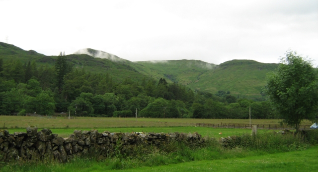 hills with mist across them seen from beinglas campsite near loch lomond